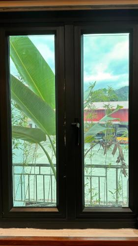 a window with a view of a beach through it at Cat homestay in Hoàng Ngà