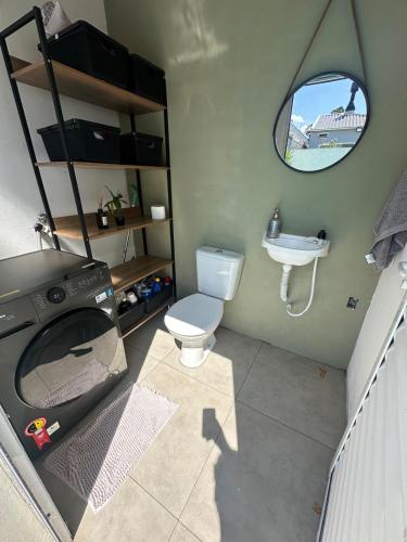 a small bathroom with a toilet and a sink at Casa de 2 dormitórios com piscina in Pelotas