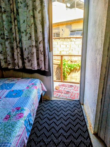 a bedroom with a bed and a window with a view at Casinhas Interior Mg in Antônio Prado