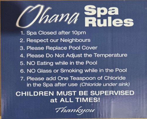 a sign for a spaastery with a list of treatments at Ocean Views at Rapanui Lodge- 4BR Gem with Parking in Christchurch