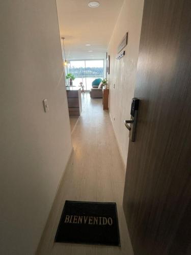 a door leading to a hallway with a sign that reads hermetino at Apartamento con vista al lago Sochagota in Paipa
