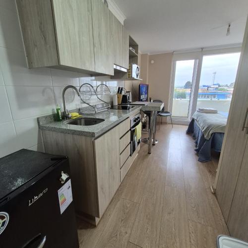 a kitchen with a sink and a counter top at Departamento Central Osorno 2 in Osorno