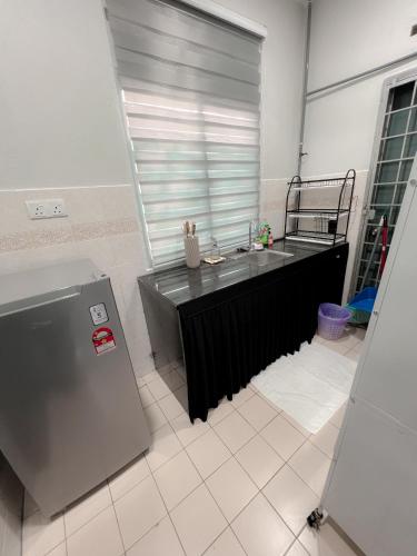 a kitchen with a sink and a large window at Lanuna Homestay Banting in Banting