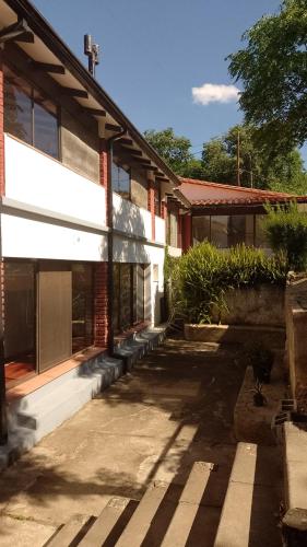 a building with a lot of windows on it at Ribera Sur Hotel - Los Algarrobos - Tanti in Tanti