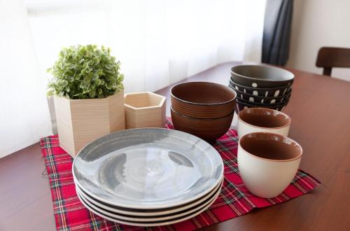 a wooden table with plates and potted plants on it at GS43名古屋 栄Area観光ビジネス周辺アクセス最高 in Nagoya