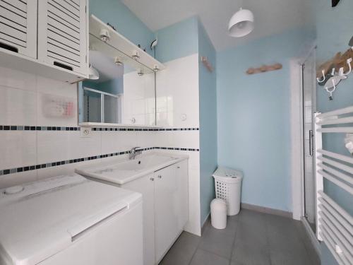 a white bathroom with a sink and a mirror at Maisonnette près du centre, proche plage et commerces - FR-1-476-84 in LʼAiguillon-sur-Mer