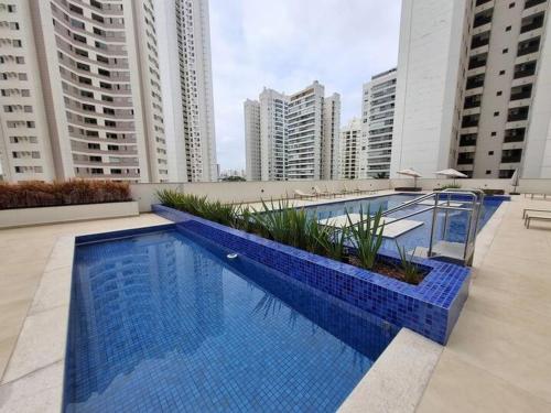 a large blue swimming pool on a building with tall buildings at Top10,Lava-Seca,AR,Sacada,200m Shopping Aurora,Gleba Palhano in Londrina