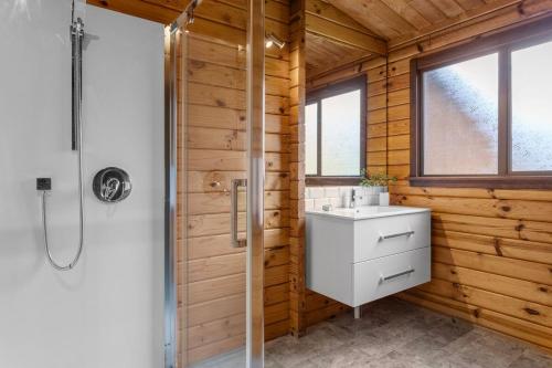 a bathroom with a white sink and a shower at The Wee Glen - Peaceful Country Retreat in Bennetts