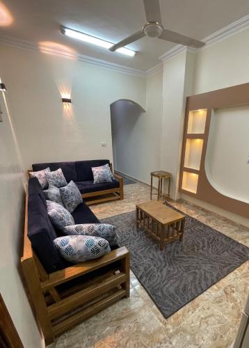 a living room with a couch and a table at Luxe Nest Guest House Apartment 102 in Luxor