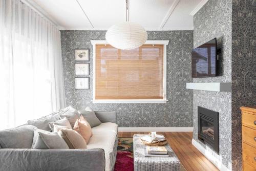 a living room with a couch and a fireplace at Fitzs Folly in New Plymouth