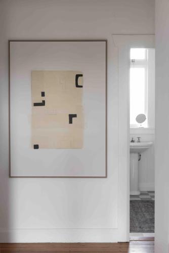 a white room with a picture on a wall at Fitzs Folly in New Plymouth
