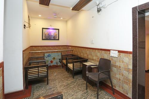 a waiting room with chairs and tables in a building at Hotel O Relax in Gwalior