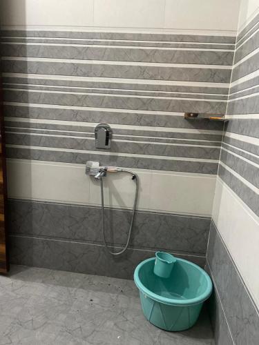a bathroom with a shower with a blue bucket at Full Independent Home for Vaction, Tours, Marrige Parties,Short time stay in Amritsar
