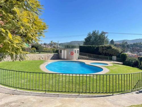 a fence around a swimming pool in a yard at SE ARRIENDA habitación individual in Quilpué