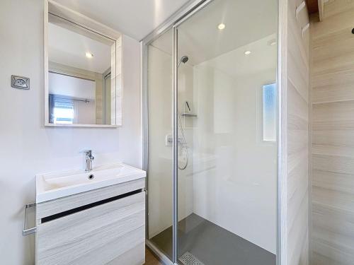 une salle de bain avec un lavabo et une douche dans l'établissement Mobil-Home Confort 6p, 3 Chambres, 2 SDB, Plage à 200m, Piscine Chauffée, Fitness, Wifi Gratuit - FR-1-361A-84, à Jullouville