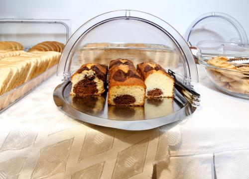a tray of cakes on a table in a bakery at Hotel Astron in Kardítsa