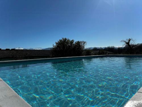 une grande piscine avec de l'eau bleue dans l'établissement Villa With Pyrenees View Near Foix, à Cassagne