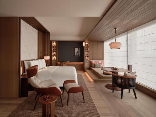 a hotel room with a bed and a living room at Patina Osaka in Osaka