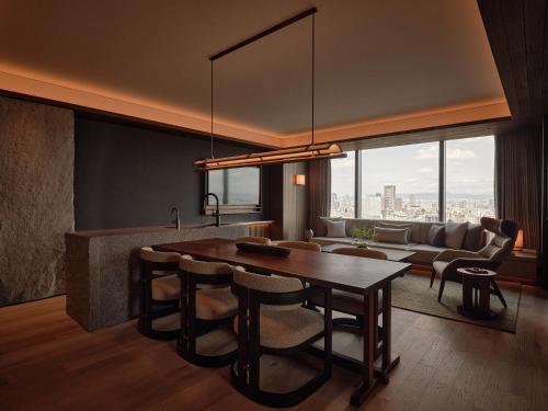 a living room with a table and a couch at Patina Osaka in Osaka