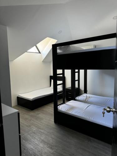 two bunk beds in a room with a skylight at The Party Pad in Angeles