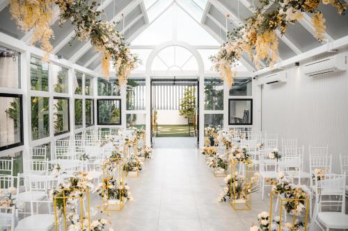 a wedding venue with white tables and flowers at D ELEGANCE GRAND BANDAR SERI ALAM in Masai