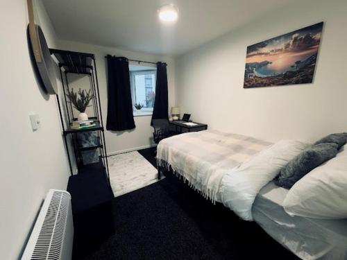 a bedroom with a bed and a window at 248 Halls in Middlesbrough