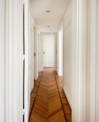 an empty hallway with white walls and wood floors at Classic Timeless Palermo Retreat in Buenos Aires
