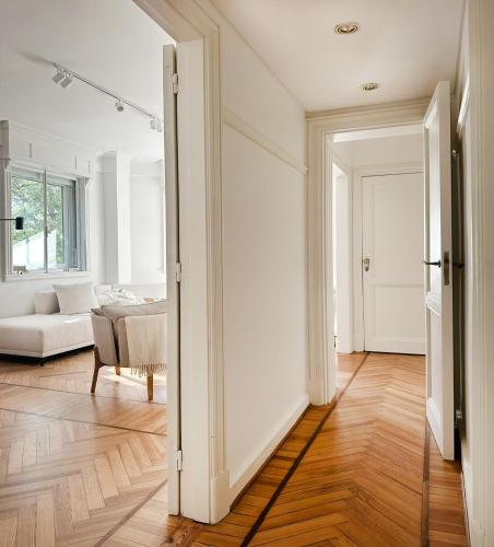 an open door into a living room with a couch at Classic Timeless Palermo Retreat in Buenos Aires