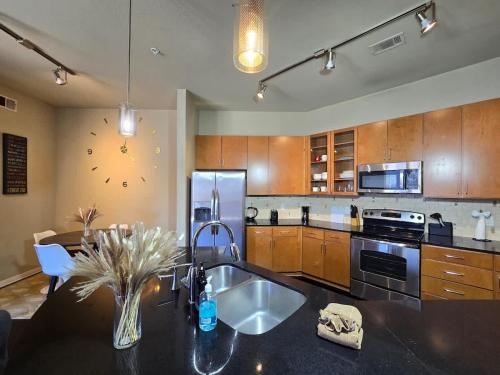 a kitchen with a sink and a refrigerator at Galleria Luxury Stay Pool Gym Stunning Views in Houston
