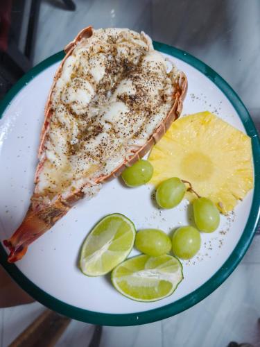 a plate of fish with grapes and lime slices at Da Pink And White Palace in Nassau