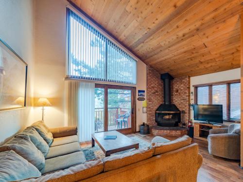 a living room with a couch and a fireplace at Austria Hof Lodge in Mammoth Lakes