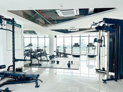 a gym with a lot of exercise equipment in a building at Gin Homestay - Nera Garden Huế in Thôn Văn Dương