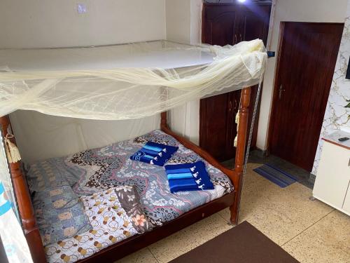 a bedroom with a bunk bed with a canopy at Kabale studio apartments in Kabale