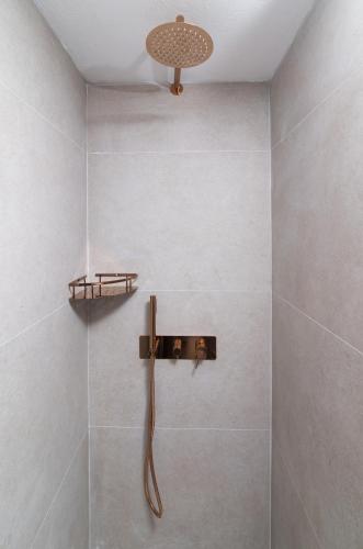 a bathroom with a shower with a shower head at Kalamaki-Sunset - Scenic Sunset & Sea Views - Steps from Shore! in Kalamaki Heraklion