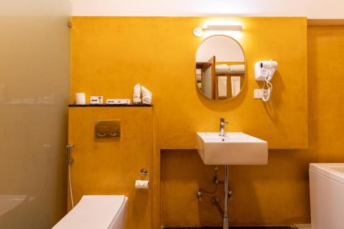 a bathroom with a sink and a mirror at La Moon Puducherry in Puducherry