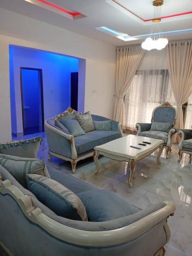 a living room with couches and a coffee table at Lamaisu Homes Block 3 in Abuja