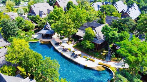 an aerial view of a house on a river at WandaVista Resort Khum Wang Nuea Chiang Mai清迈万达文华酒店北国之宫 in Chiang Mai