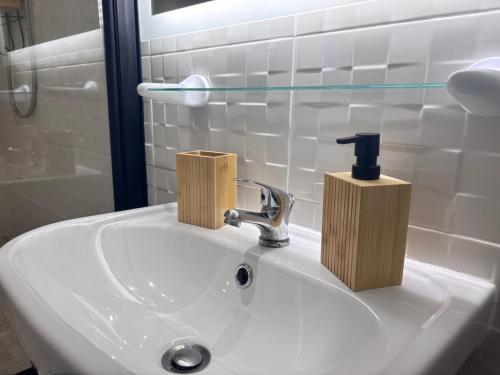 a bathroom sink with a soap dispenser on it at SYLOU - Centre historique, 4 personnes, Climatisation, Netflix, Comédie, Tramway, Gare in Montpellier