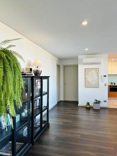 a living room with a book shelf with books at CBD Penthouse Retreat - Stunning Ocean & City View in Wollongong