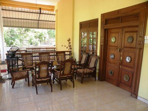 a dining room with a table and chairs in a room at Henderson Airport Residence in Negombo