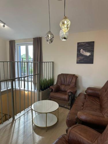 a living room with a couch and a table at Inn West Hotel by Pysanka in Kolomyya