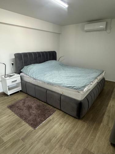 a large bed sitting in a room with a floor at Villa Veronika in Skopje