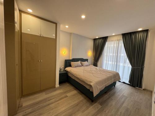 a bedroom with a bed and a large window at Cosy Apartment-Dream Location in Addis Ababa in Addis Ababa