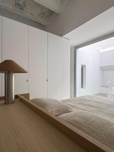 a bedroom with a large bed and a large window at Superloft in Burjassot