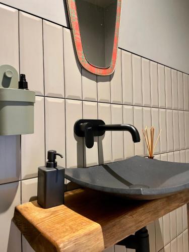 a bathroom with a sink and a mirror on a counter at D a c h a in Ventspils