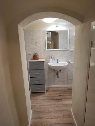 a bathroom with a sink and a mirror at La casina nel borgo in Volterra