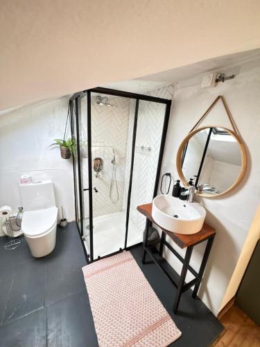 a small bathroom with a sink and a shower at KameronAppart in Yaoundé