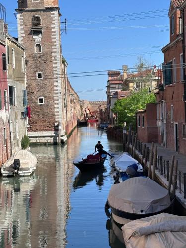 a group of boats in a canal in a city at Ca' Elena beautiful canal view Biennale in Venice