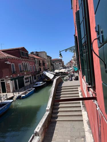 a view of a canal with boats in the water at Ca' Elena beautiful canal view Biennale in Venice