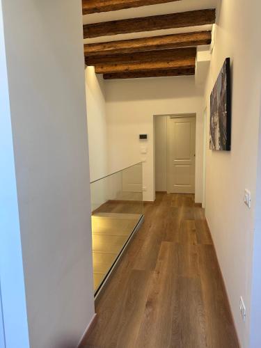 an empty hallway with wood floors and ceilings at Ca' Elena beautiful canal view Biennale in Venice